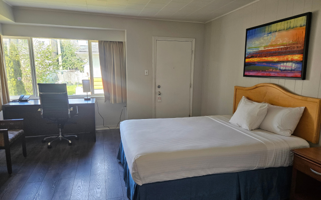 Spacious one-bedroom suite with living area at 2400 Motel