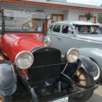Retro vehicles displayed outside 2400 Motel bungalows